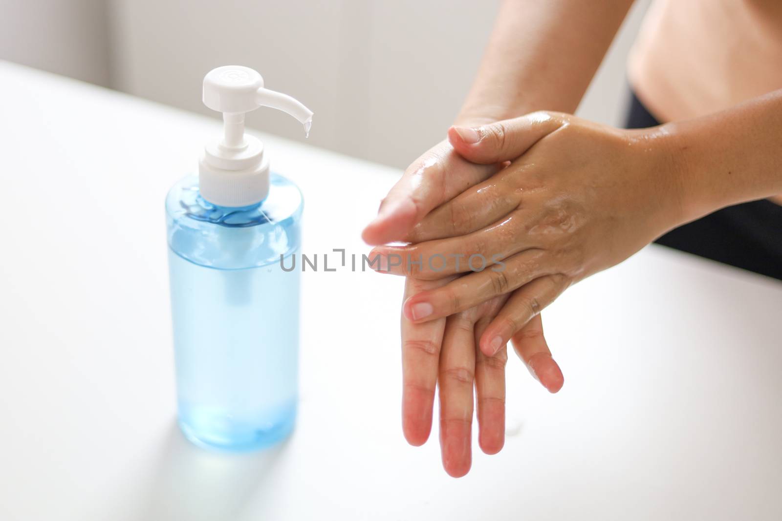 Hand applying Alcohol gel sanitazer liquid cleaning hands for pr by peandben
