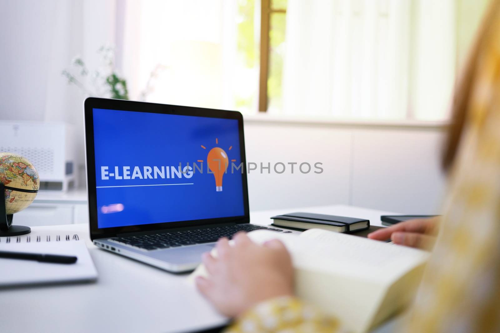 E-learning Education Internet Networking . Young businesswoman sitting and used laptop with inscription on screen e-learning. Online education e-learning.