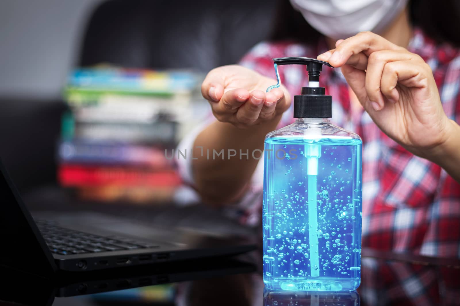 people washing hand by hand sanitizer alcohol gel for cleaning and disinfection, before typing on keyboard for working. prevention of spreading of germs during infections of COVID-19 Coronavirus