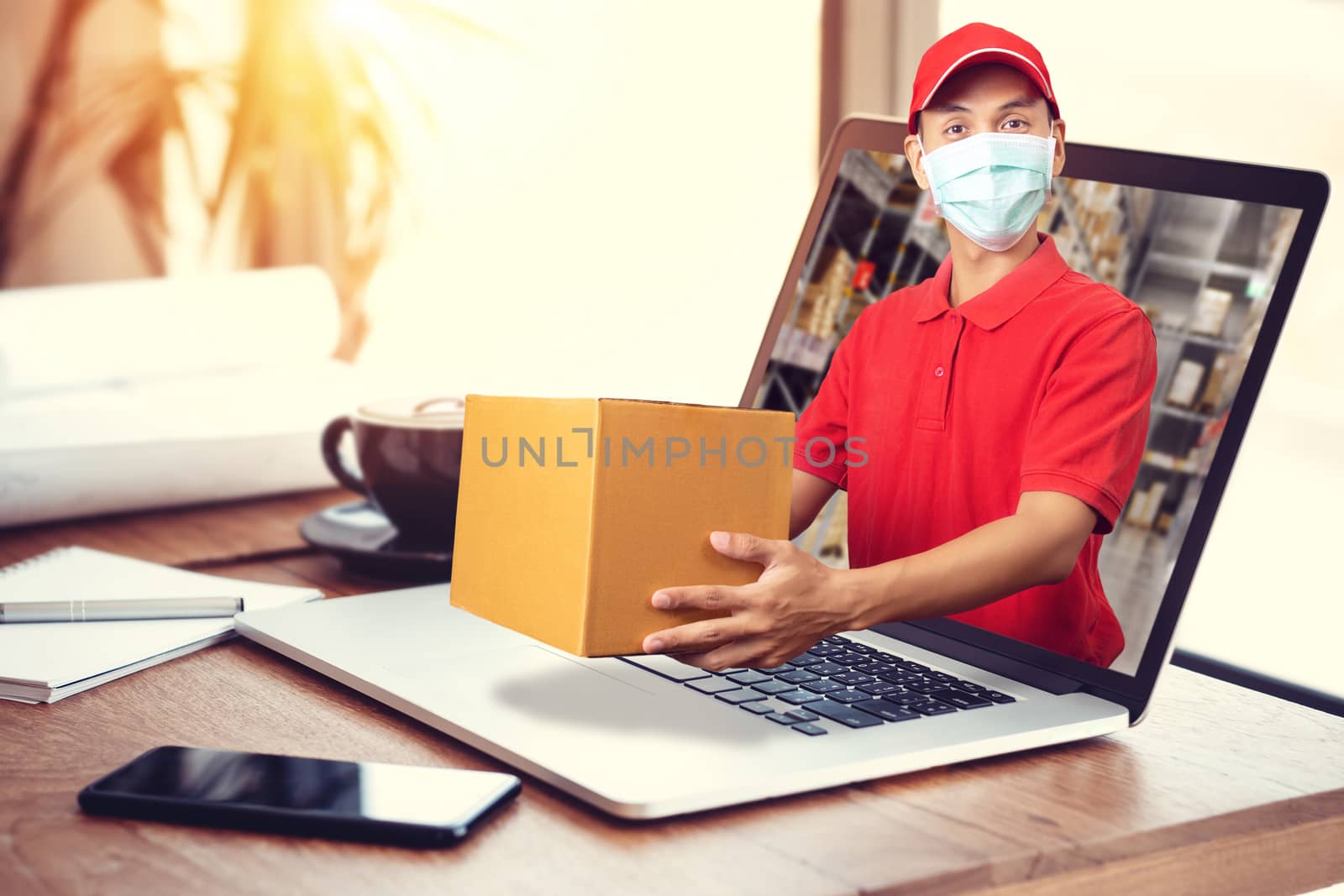 delivery man in red shirt with hygienic mask, holding goods orde by asiandelight
