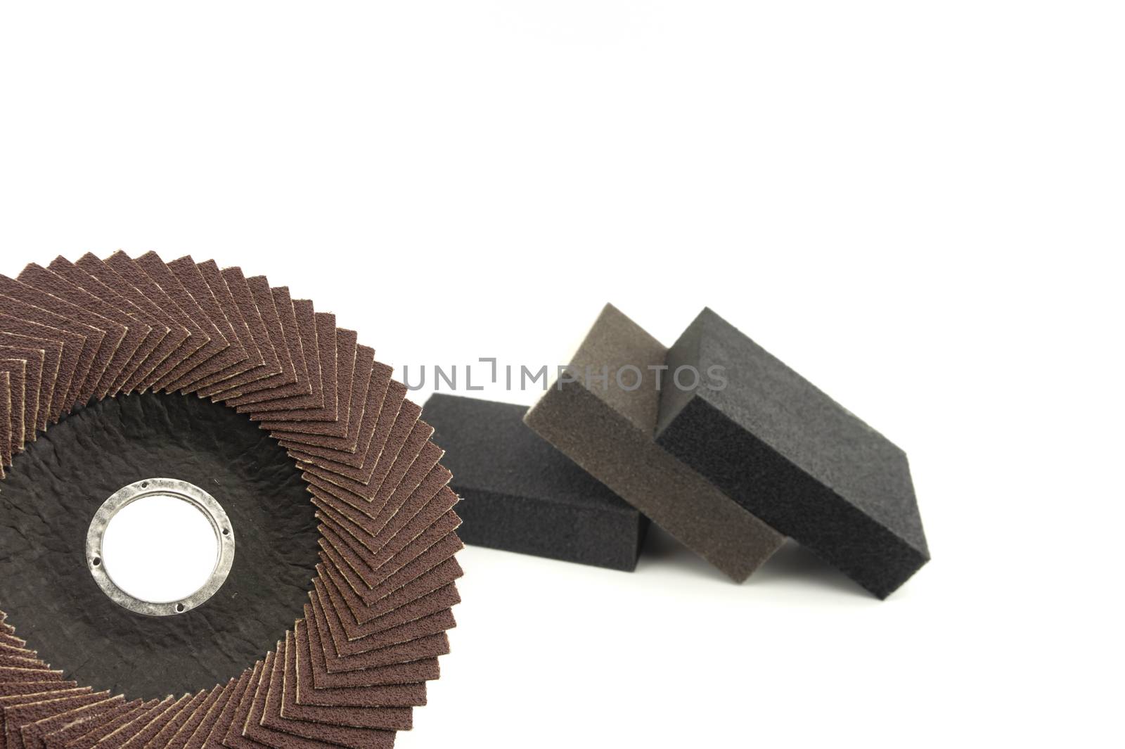 Set of different tools for grinding - flap disc for angle grinder and abrasive sponges , isolated on white background