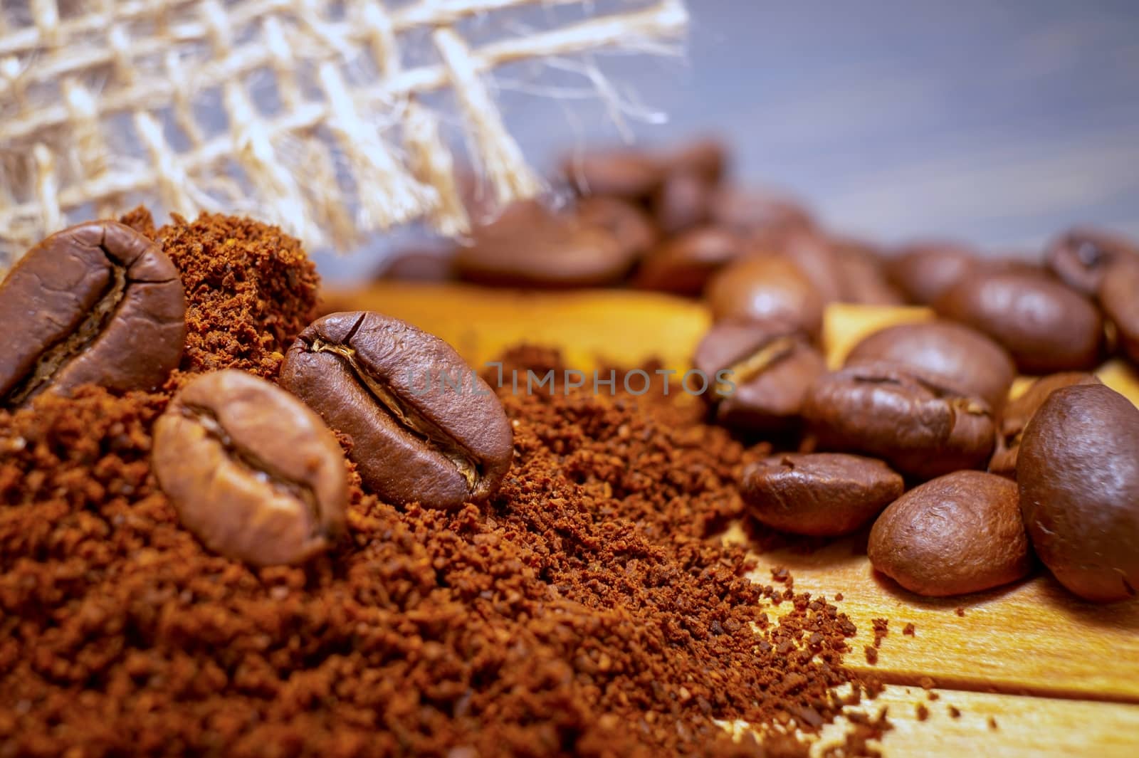 Roasted coffee beans and ground coffee in close up
