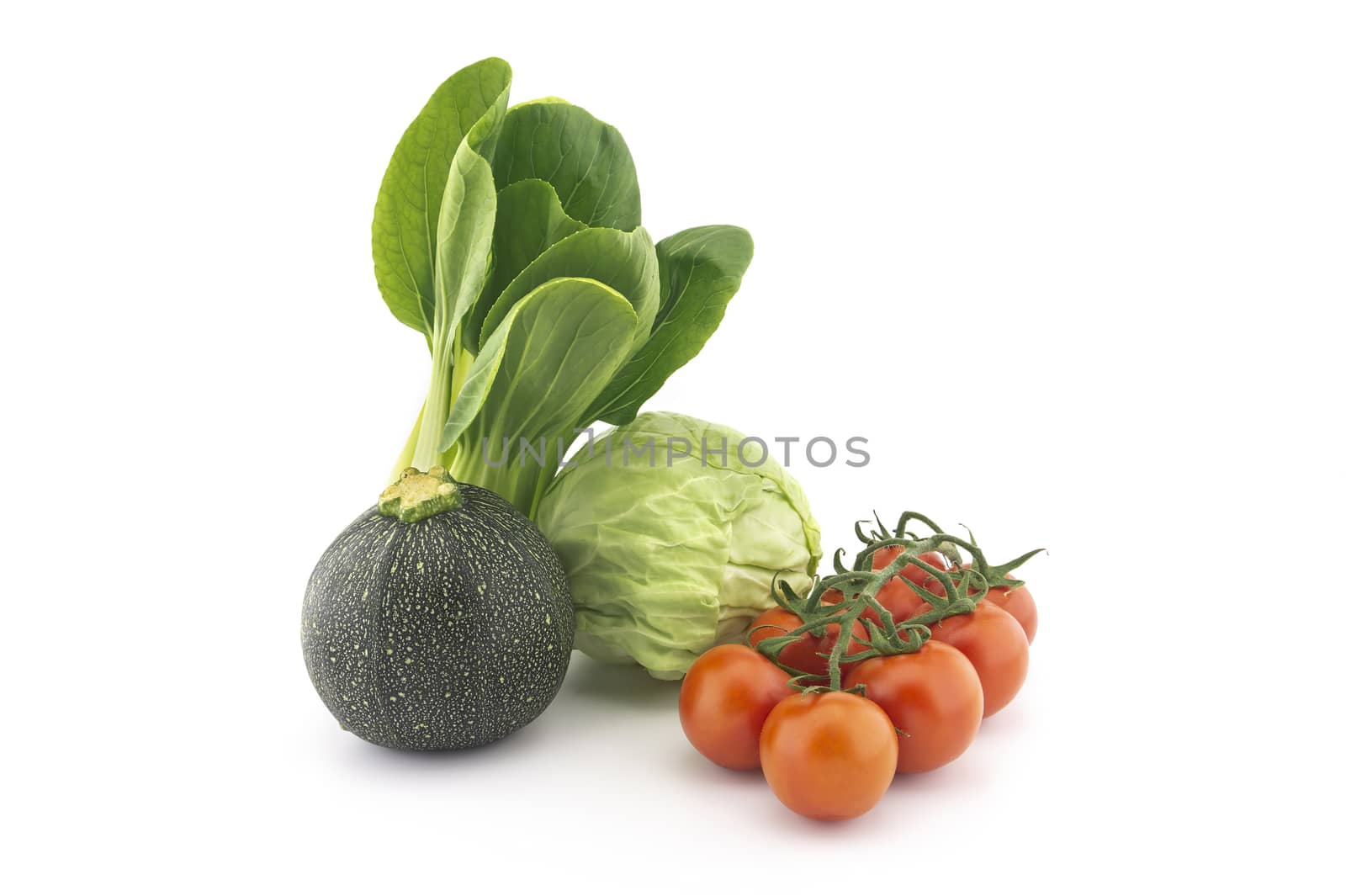 Chinese cabbage and white cabbage green round courgette or zucchini and cherry tomato twig isolated on white background