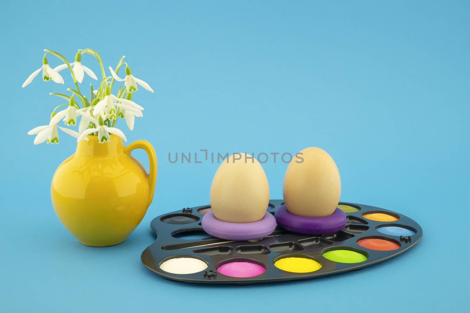 Easter egg decoration concept with paints in pallet by NetPix