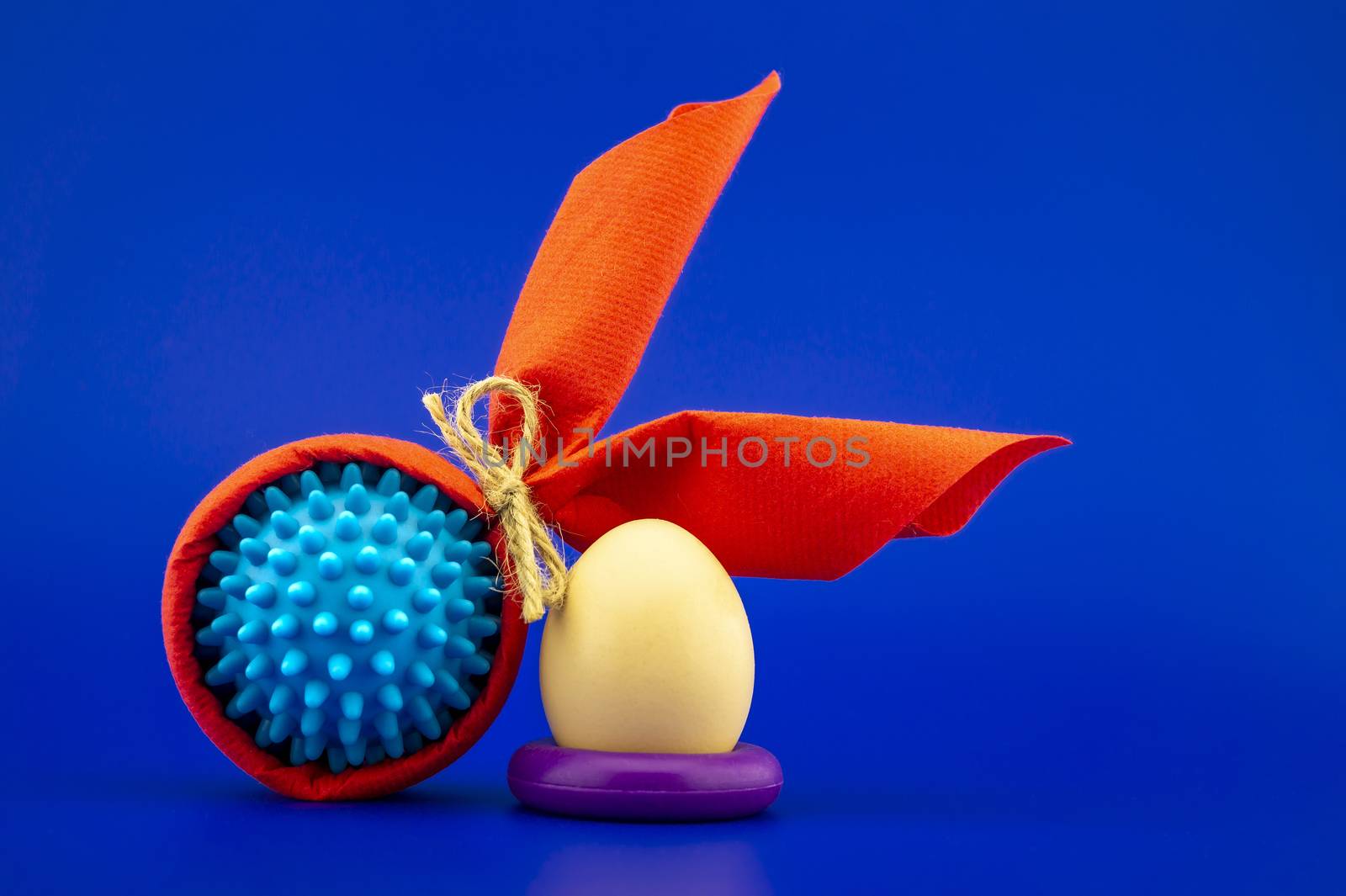 Corona virus models wrapped as gifts and Easter eggs on a blue background with copy space