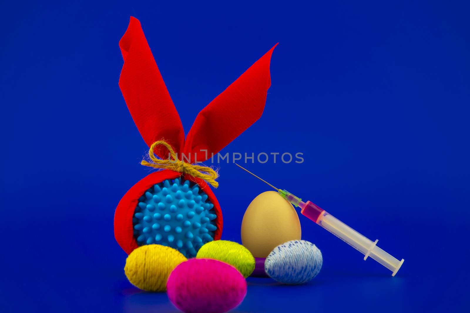 Corona virus models wrapped as gifts and Easter eggs on a blue background with copy space