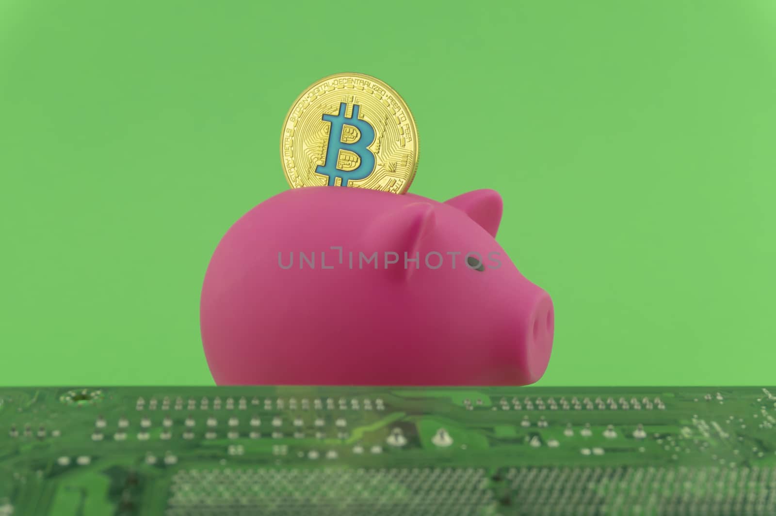 Saving using Bitcoin concept with a virtual gold coin being inserted into a pink piggy bank over a green background