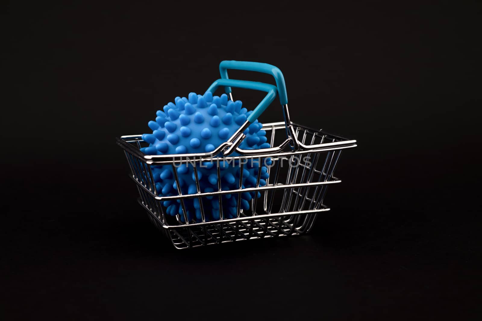 Blue virus molecule in a shopping basket conceptual of the possibility of infection with corona virus or Covid-19 over a black background