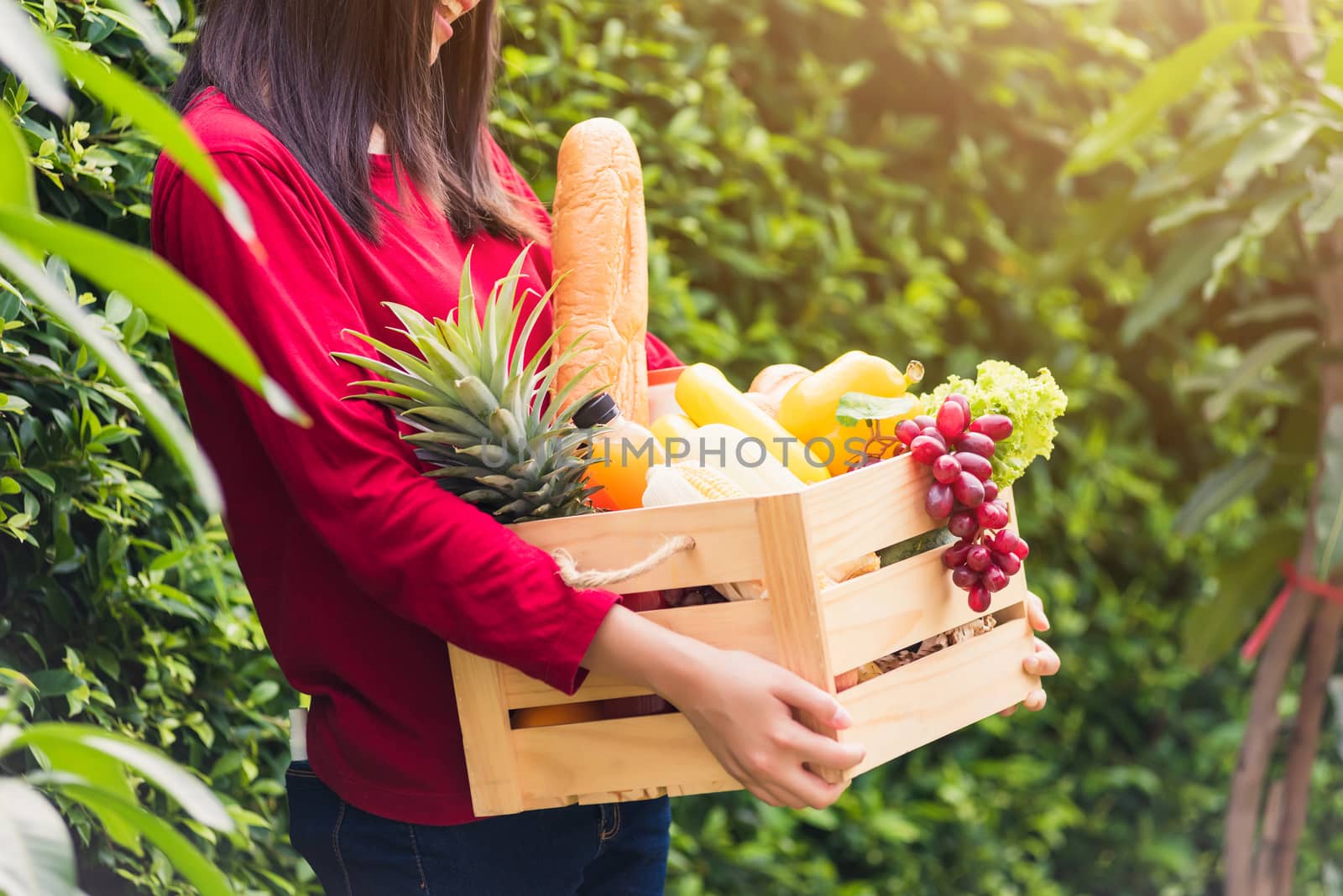 Woman farmer standing hold full fresh food raw vegetables fruit  by Sorapop