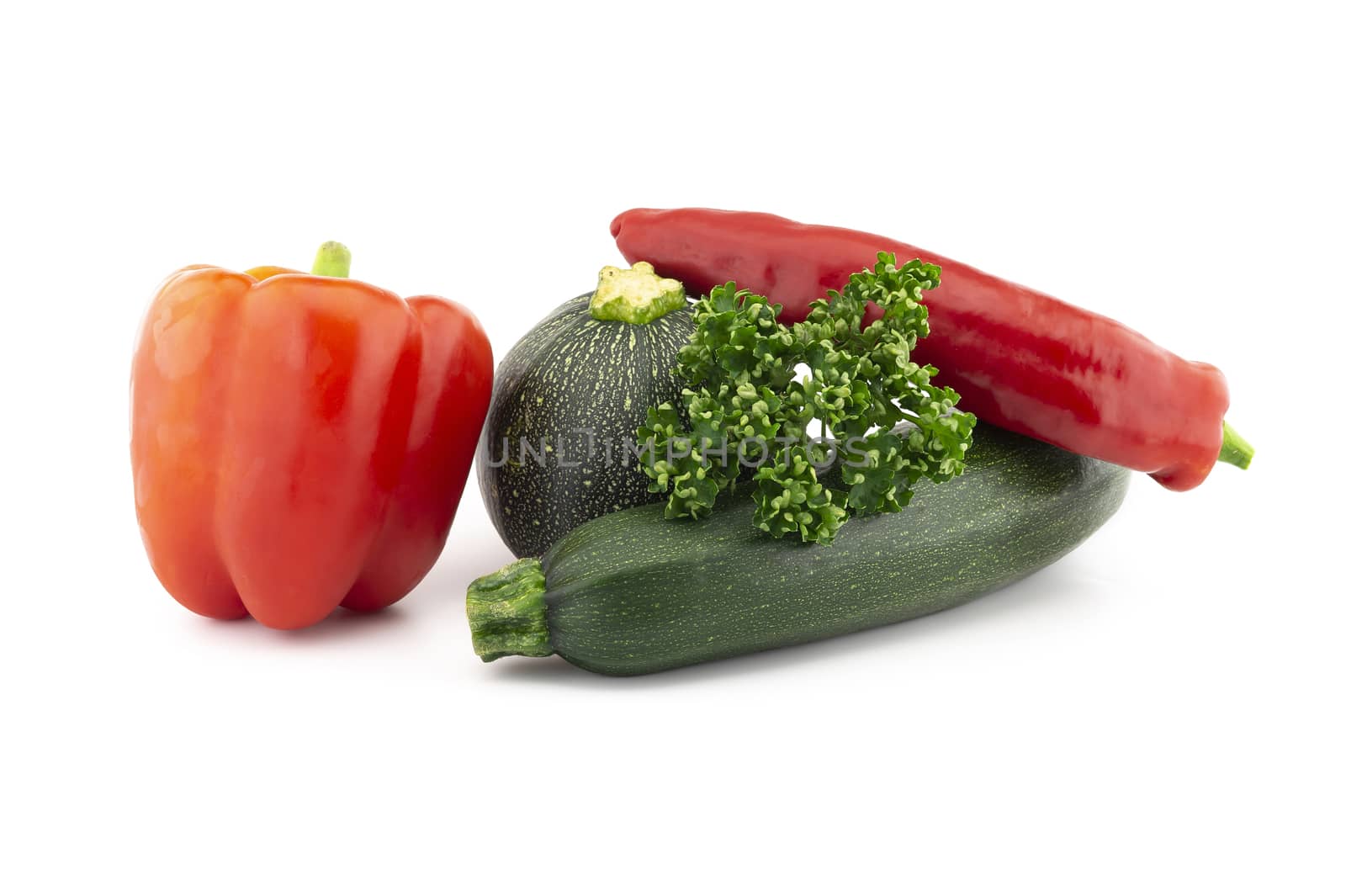 Green round and traditional courgette or zucchini, fresh parsley sprigs and red pepper isolated on white background