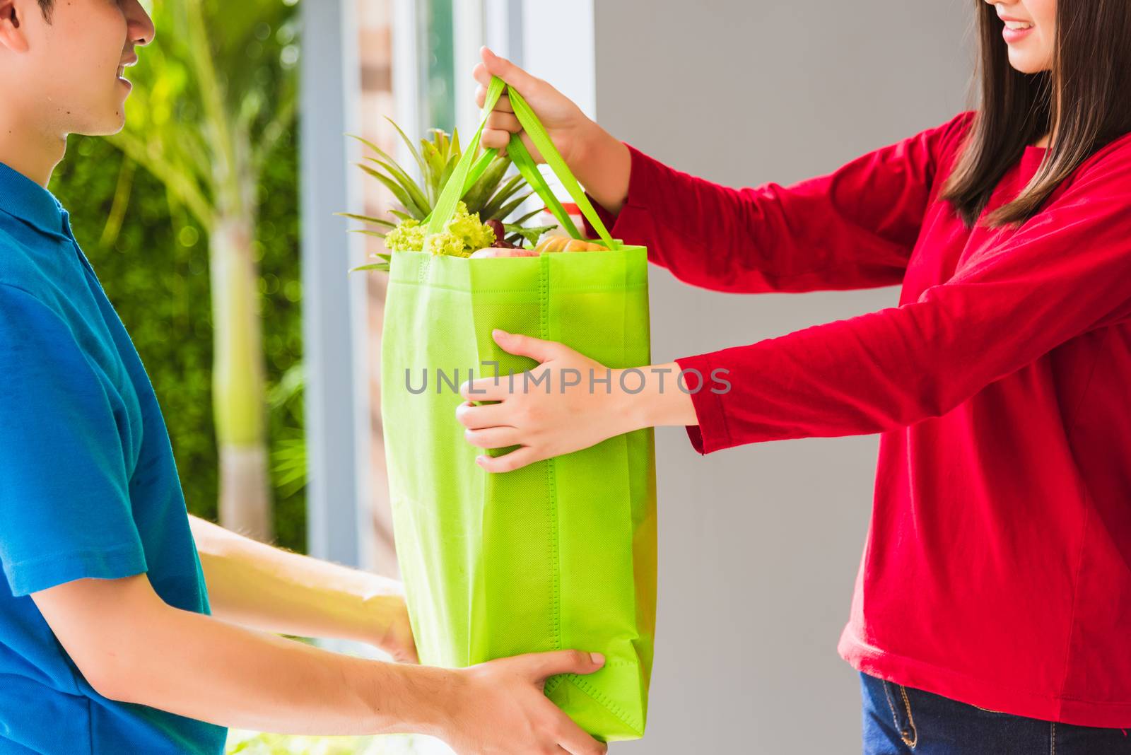 Delivery man making grocery service giving fresh vegetables and  by Sorapop