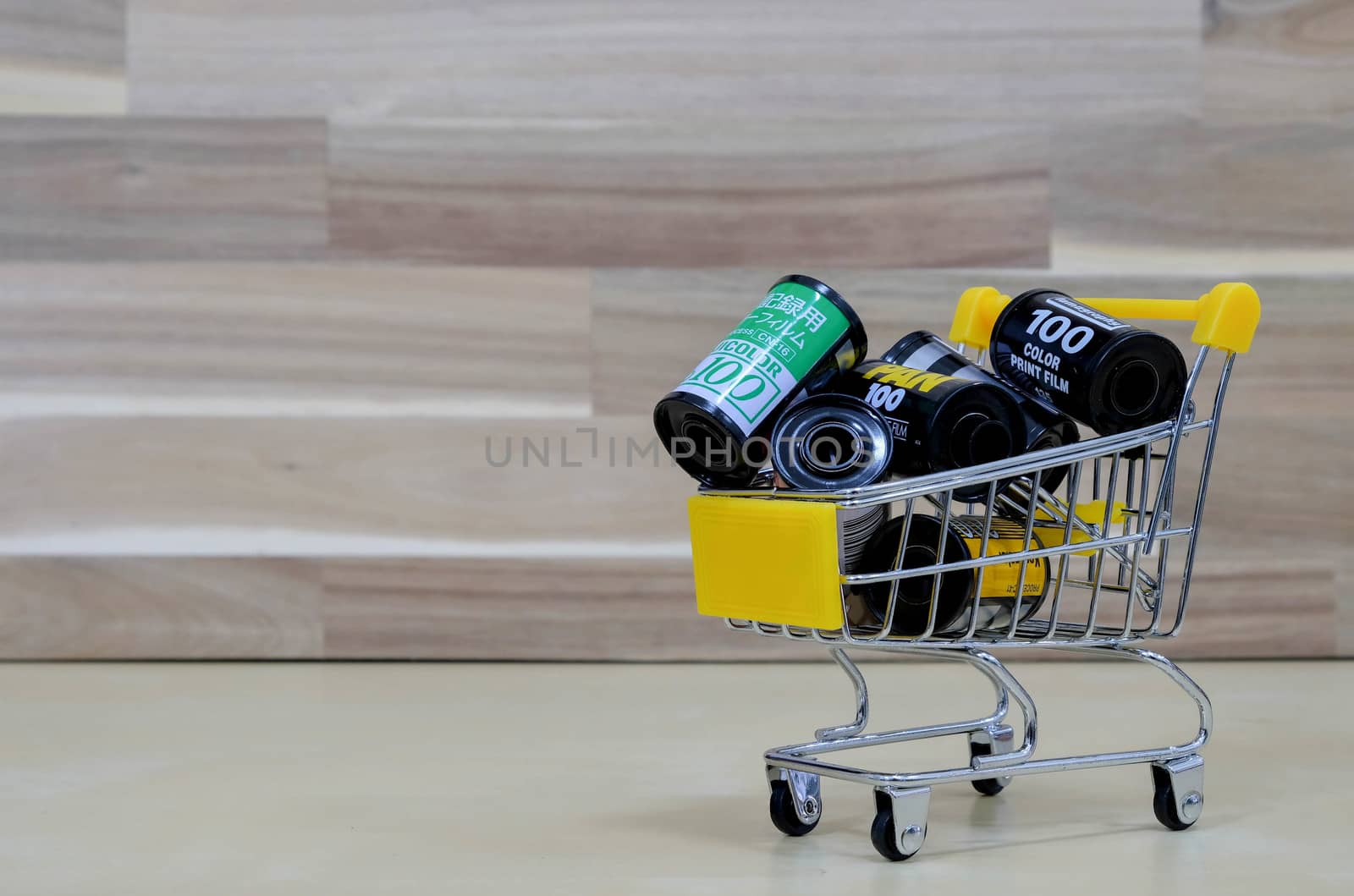 A Group of Film in The Market Cart on Wooden Background