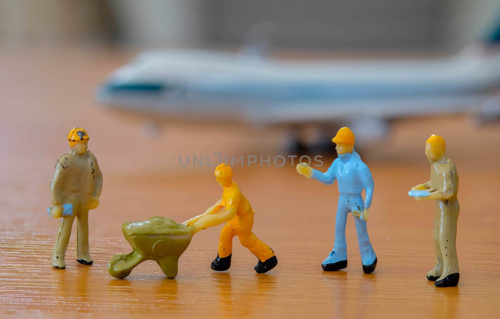 group of miniature Worker meeting to prepair The  Plane at the Airport