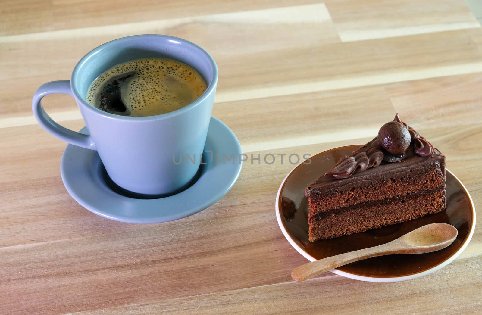 Chocolate cake and a cup of coffee on wooden table