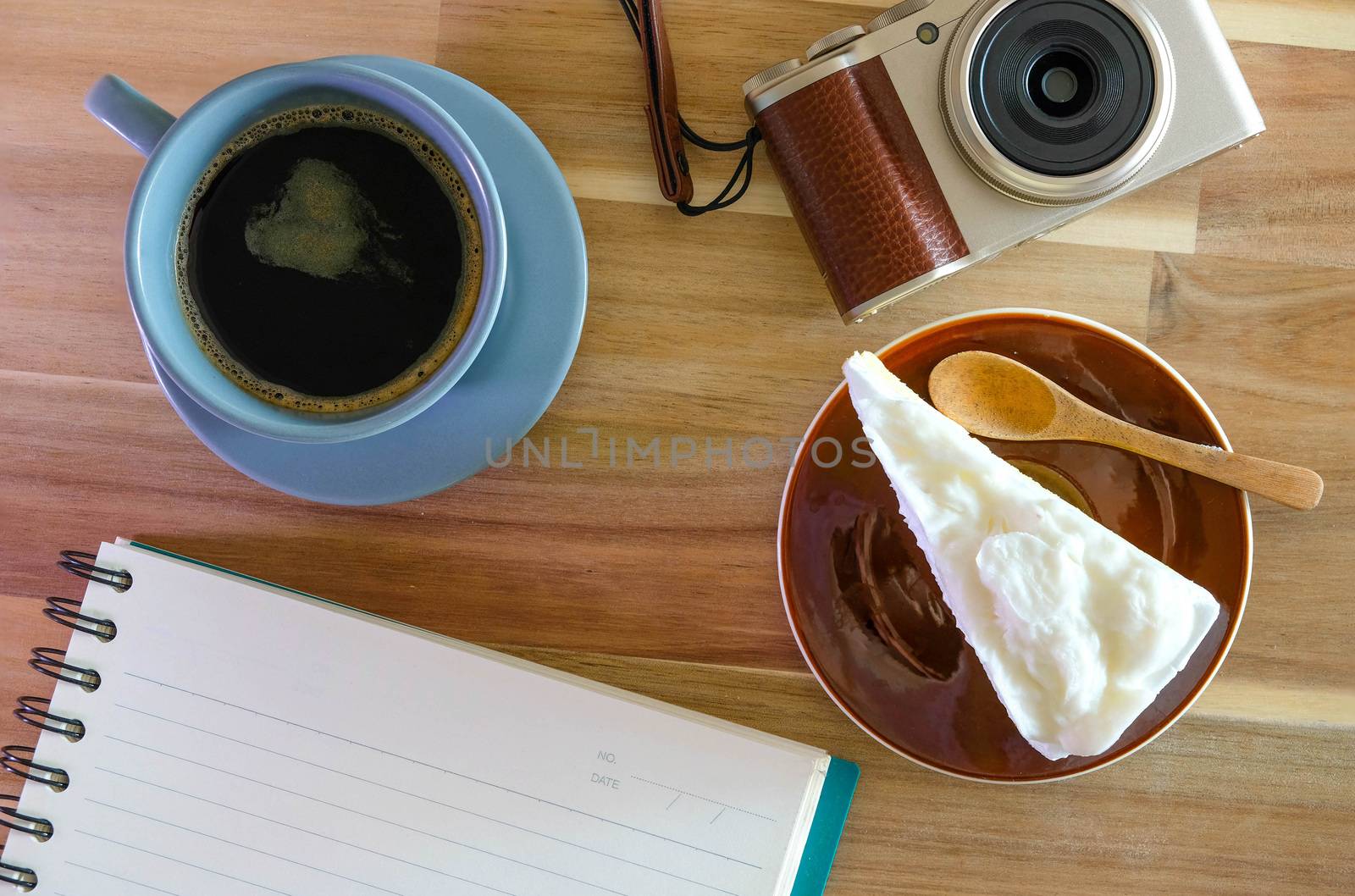 notebook, camera, coffee, coconut cake on wooden background by Bonn2210