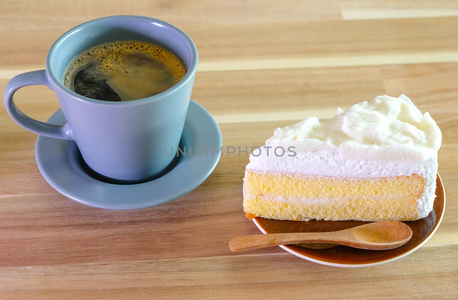 Coconut Cake and a cup of coffee on Wooden table