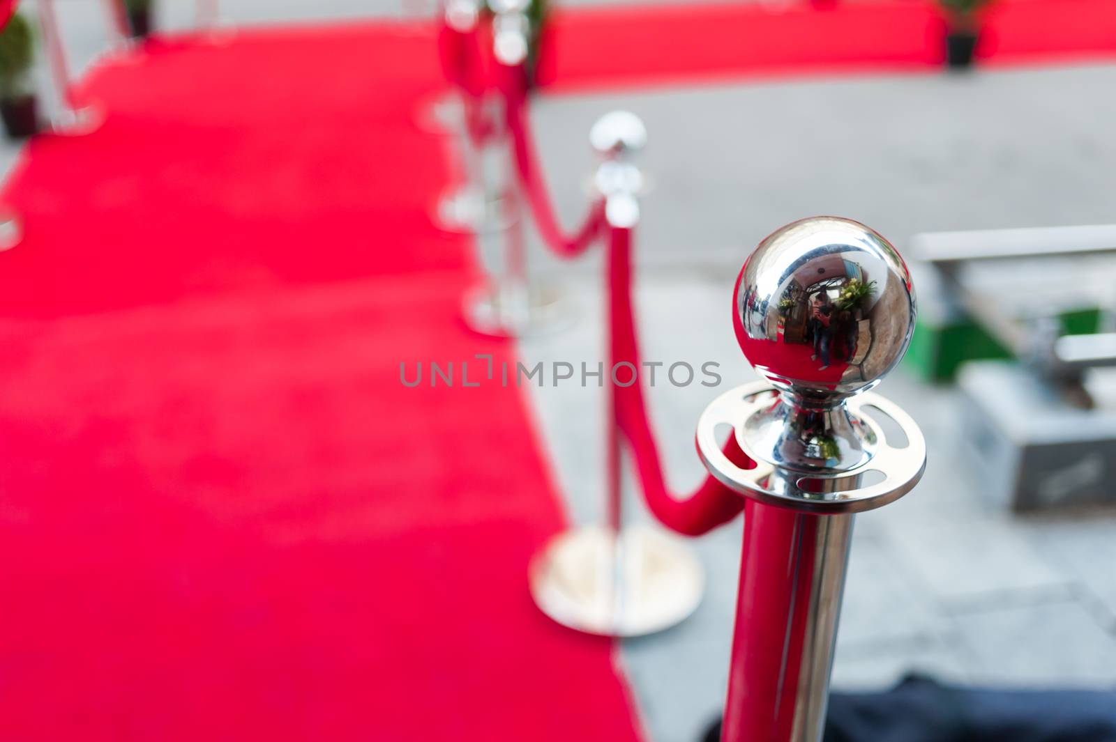 Event party.Red carpet between rope barriers in the success party. by OleksandrLipko