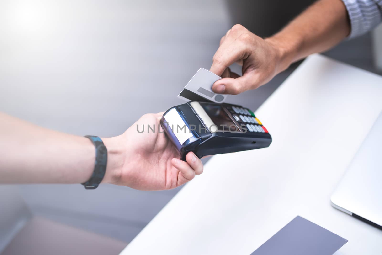 finance, payment, cash free and people concept - young man with credit card paying for coffee at city street cafe