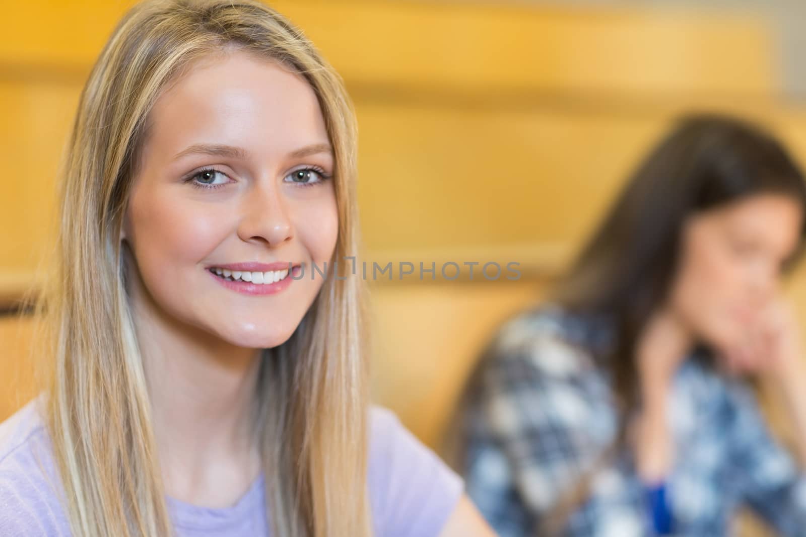 Portrait of smiling student in class in university