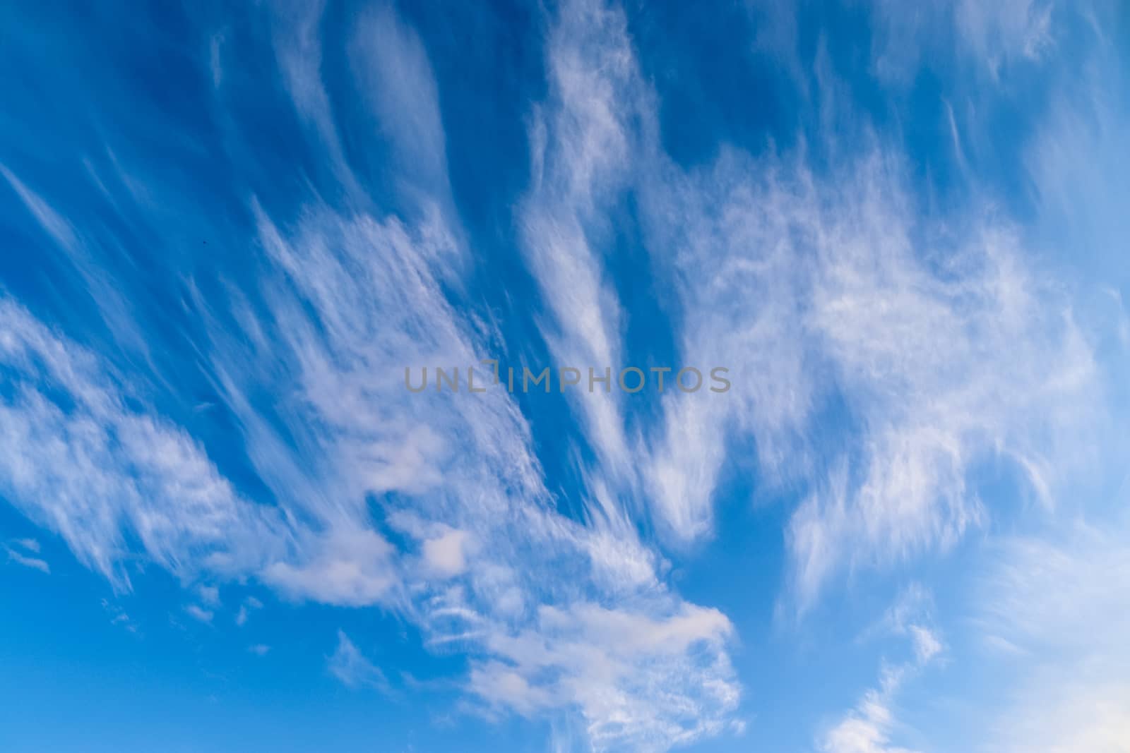 Stunning cirrus cloud formation panorama in a deep blue summer sky seen over Europe