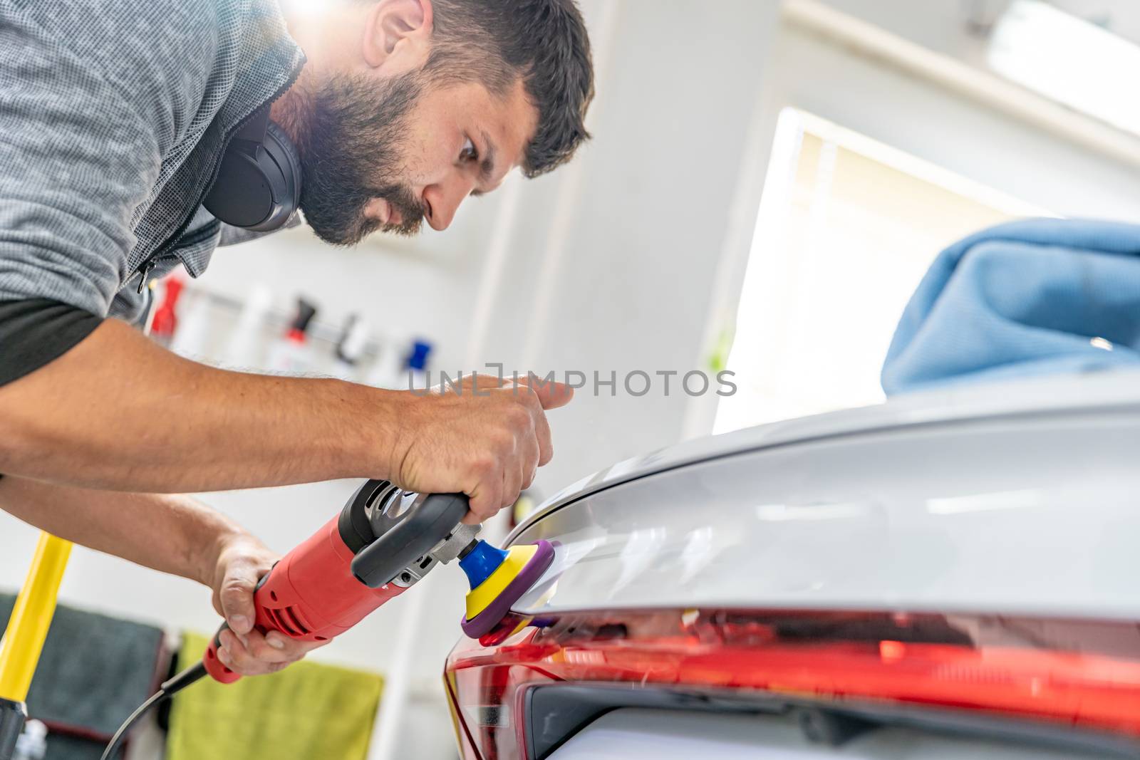 manual polishing of the body of luxury cars with the application of ceramic protective equipment.