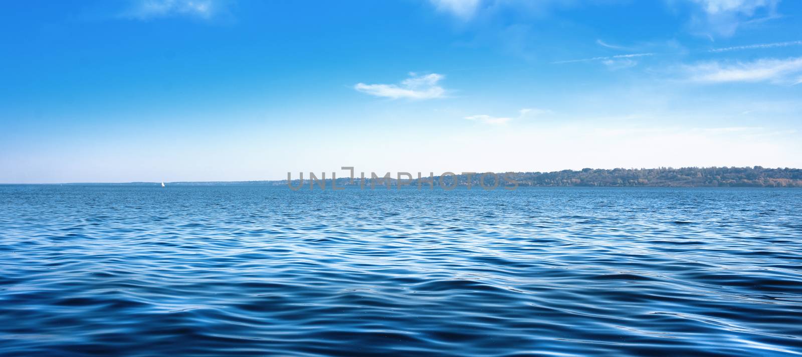 Seascape with sea horizon and almost clear deep blue sky - Background. panoramic aspect ratio by Nickstock