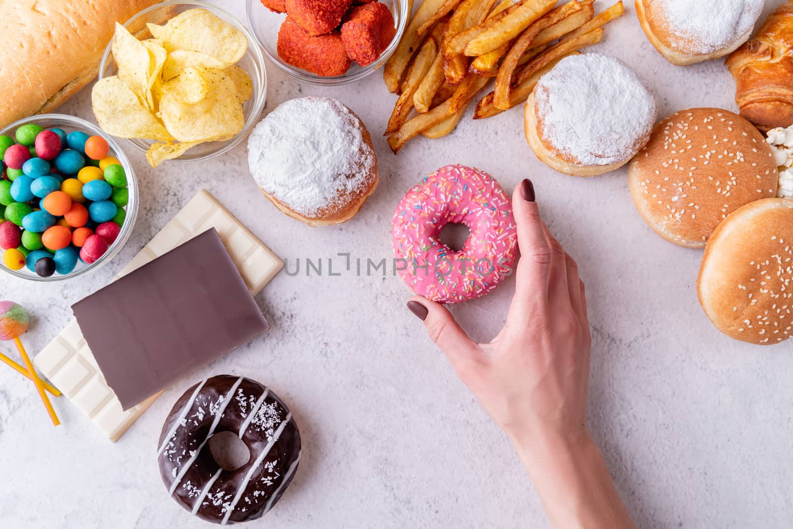 Unhealthy food and fast food with donuts, chocolate, burgers and sweets top view by Desperada