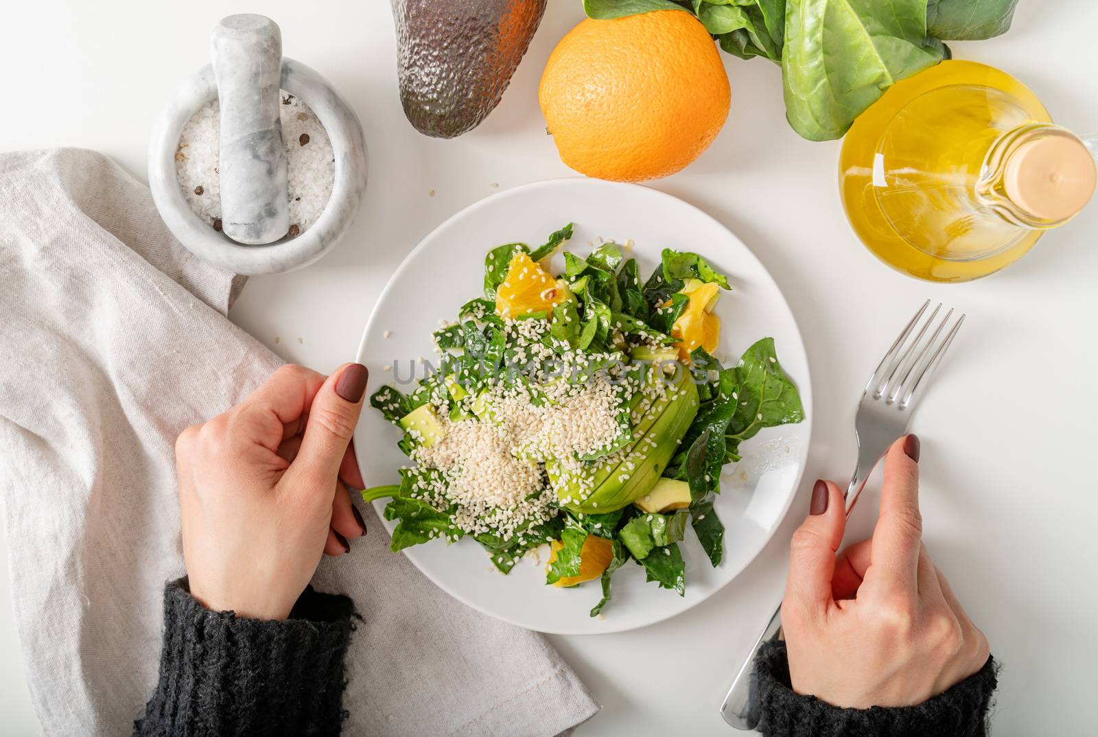 Step by step preparation of spinach, avocado and orange salad. Step 9 - the salad is ready, enjoy your meal, top view, selective focus