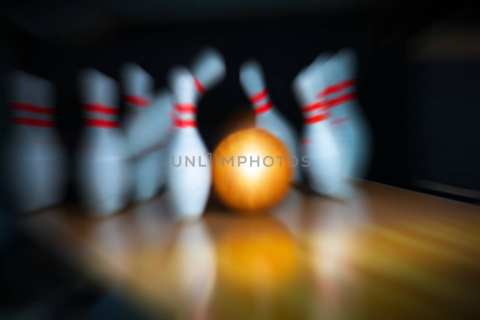 motion blur of bowling ball and skittles on the playing field