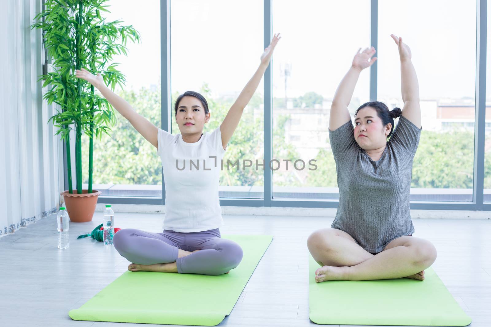 Two Asian woman yoga exercising at home  ,activity and relax at home