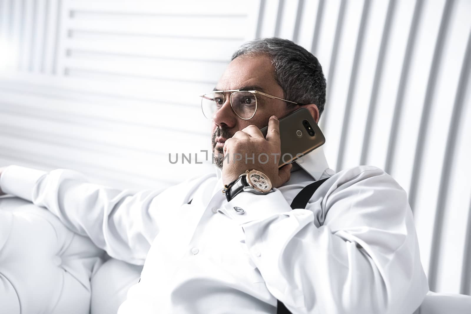 A serious man businessman talking on the phone