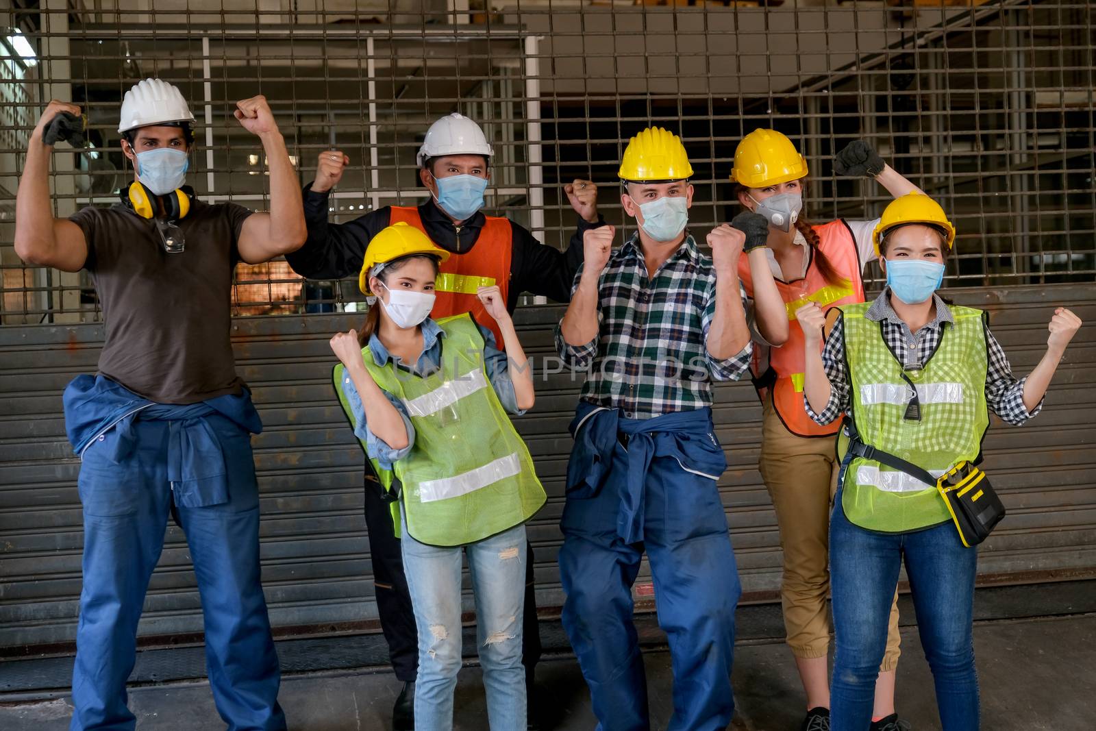 Group of people with mask show action of success and strong to fight with the disease or environment toxicants in factory