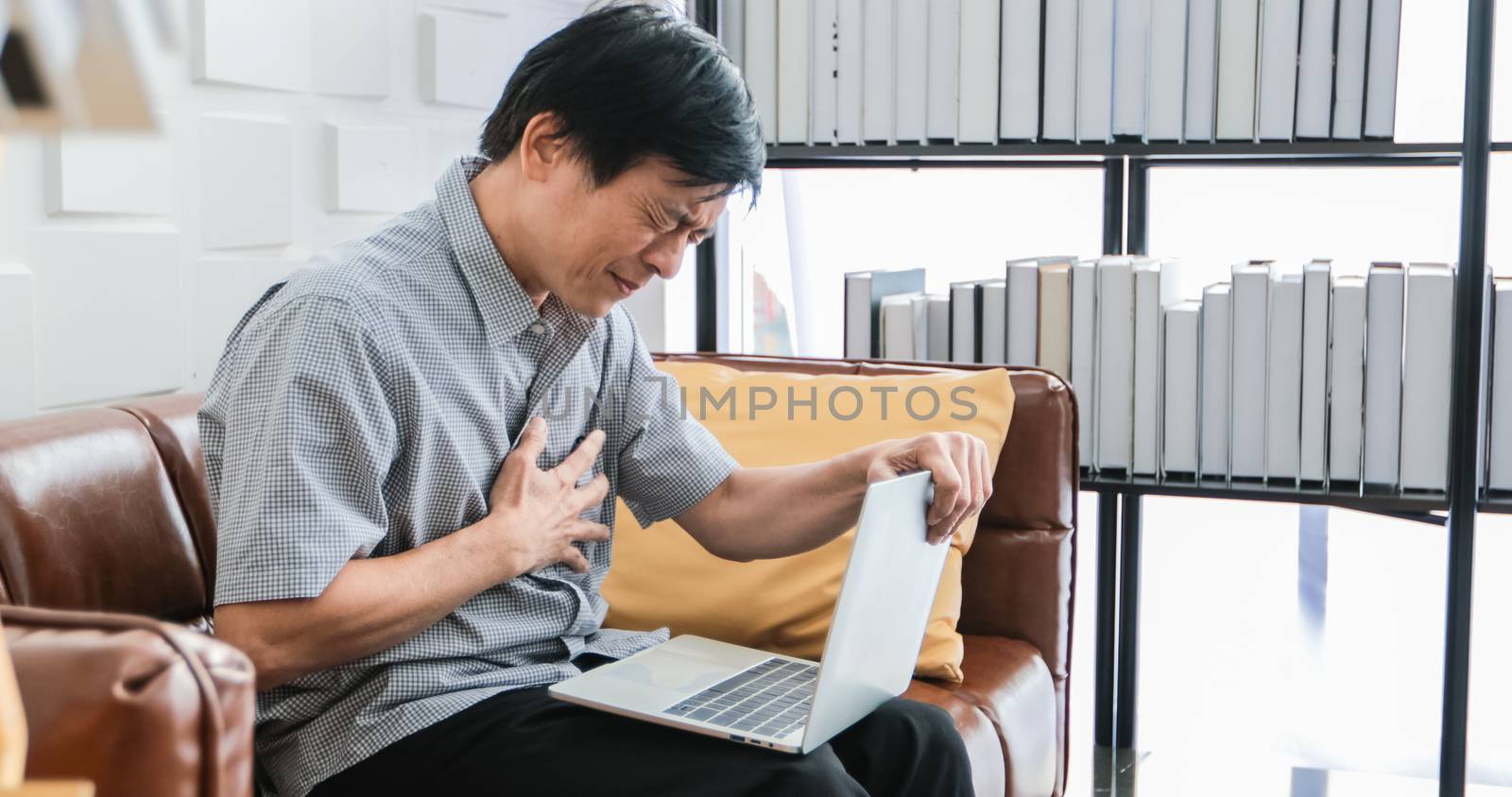 elderly Asian people work hard until they become stressed and he feel bad on his heart