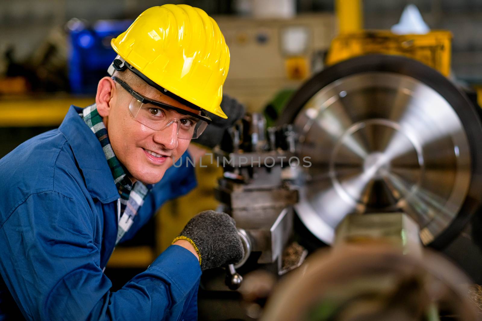 Smart technician or engineer worker man with protective uniform look to the camera and happy by nrradmin