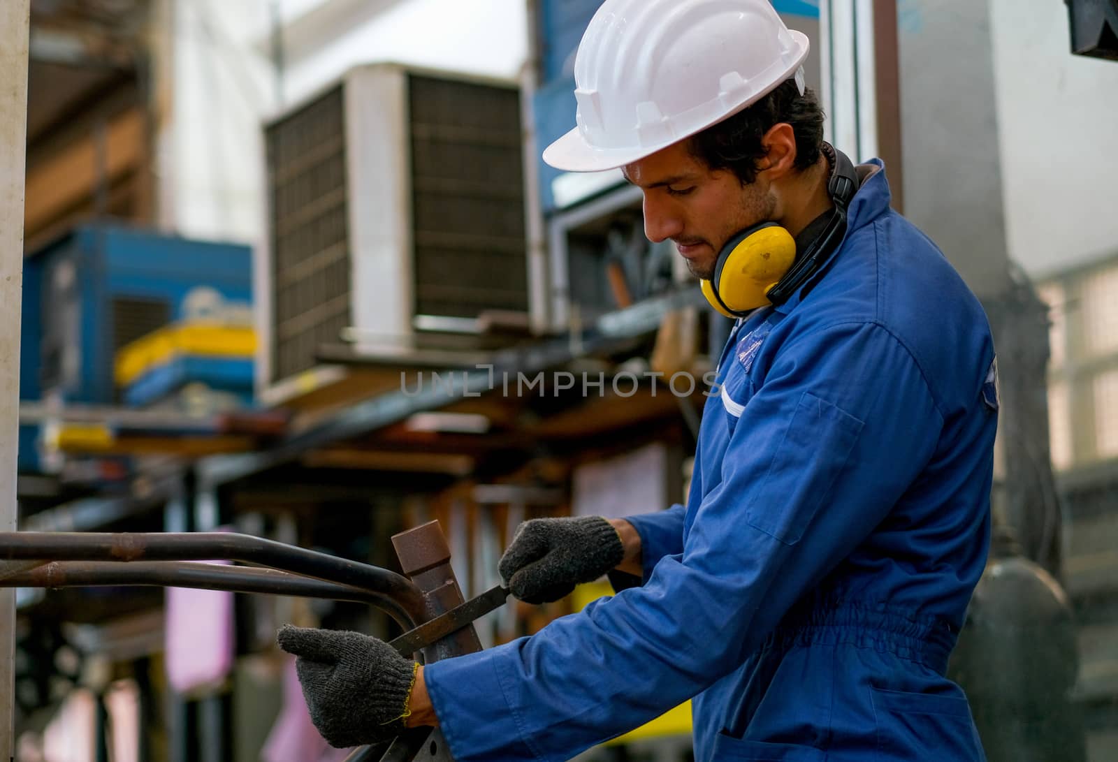 Smart worker or technician man use rasp to repair or maintenance in the factory.