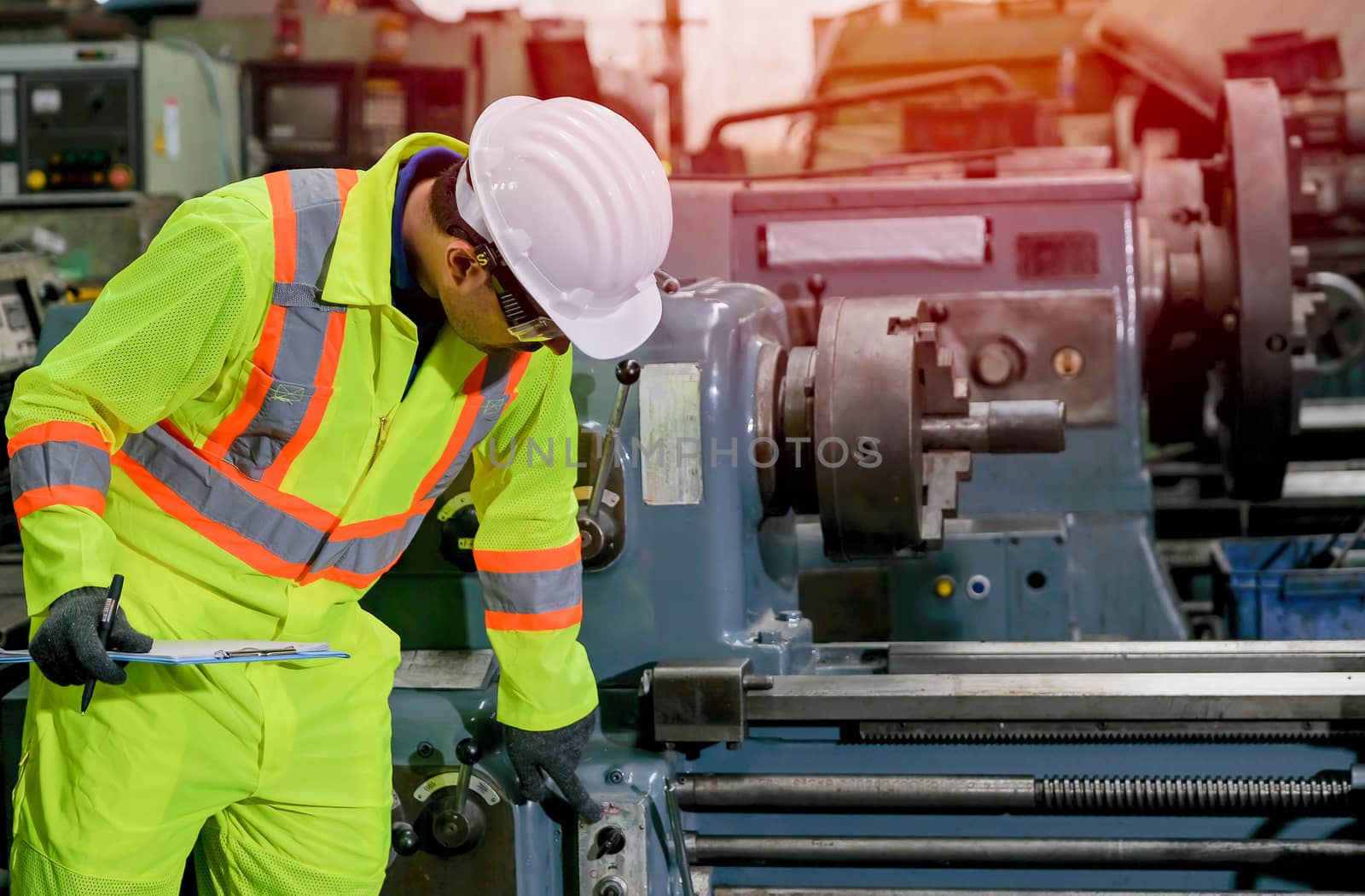 Technician man with safety uniform check and maintenance the machine in factory.