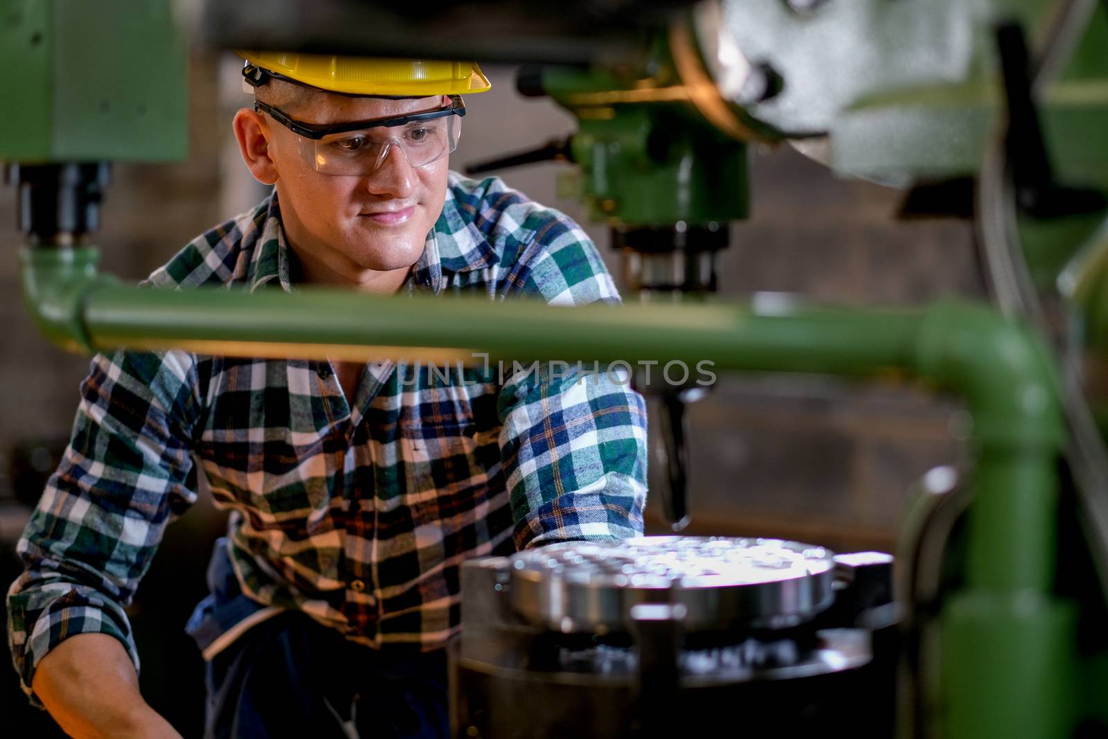 Technician or worker man work with the machine in factory with day light. Concept of good system and manager support for better industrial business.