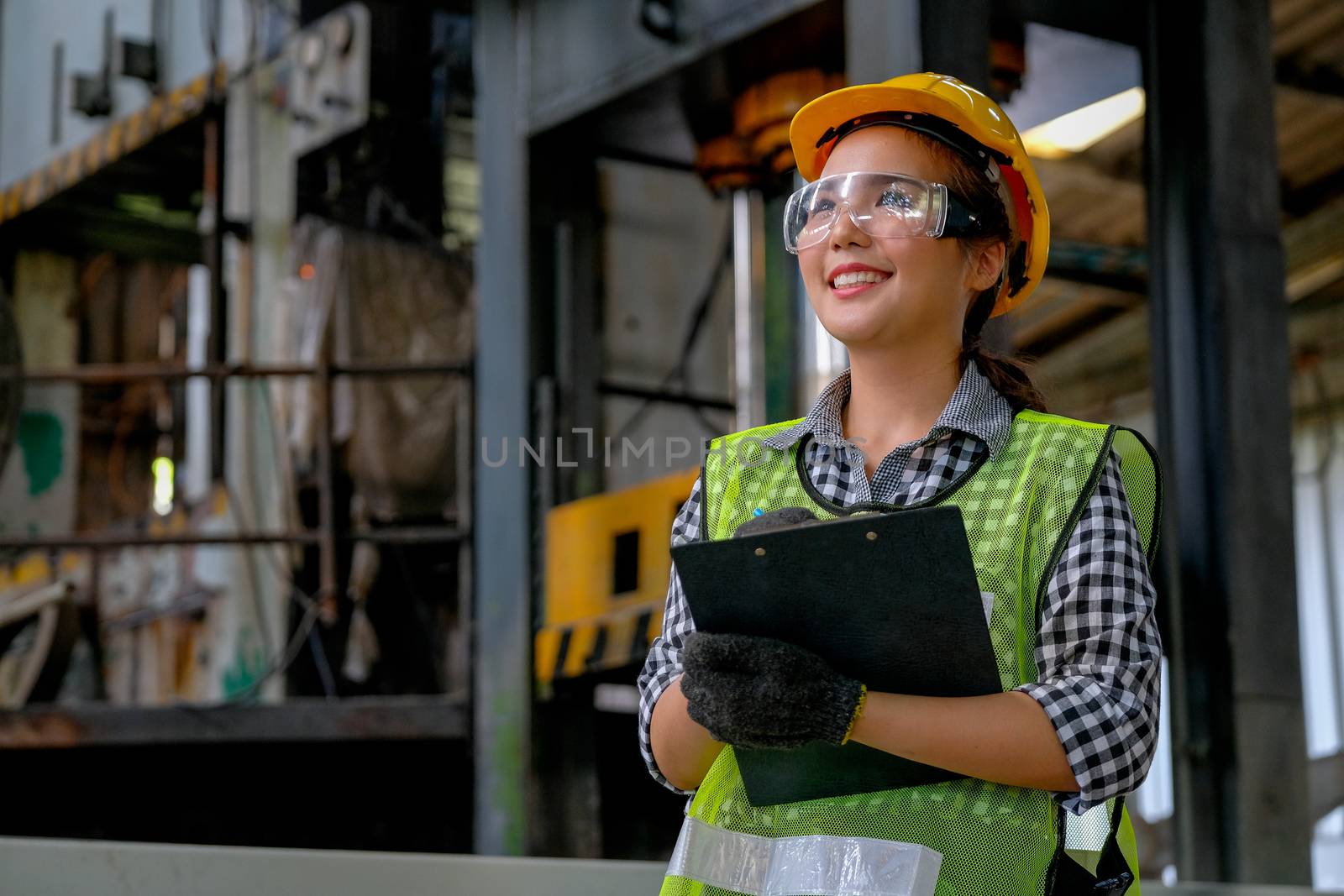 Pretty factory woman worker or technician smile and holds document file by nrradmin