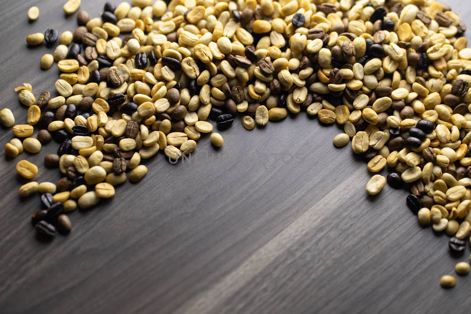 Coffee beans. Coffee beans that have not been baked on the wood floor.
