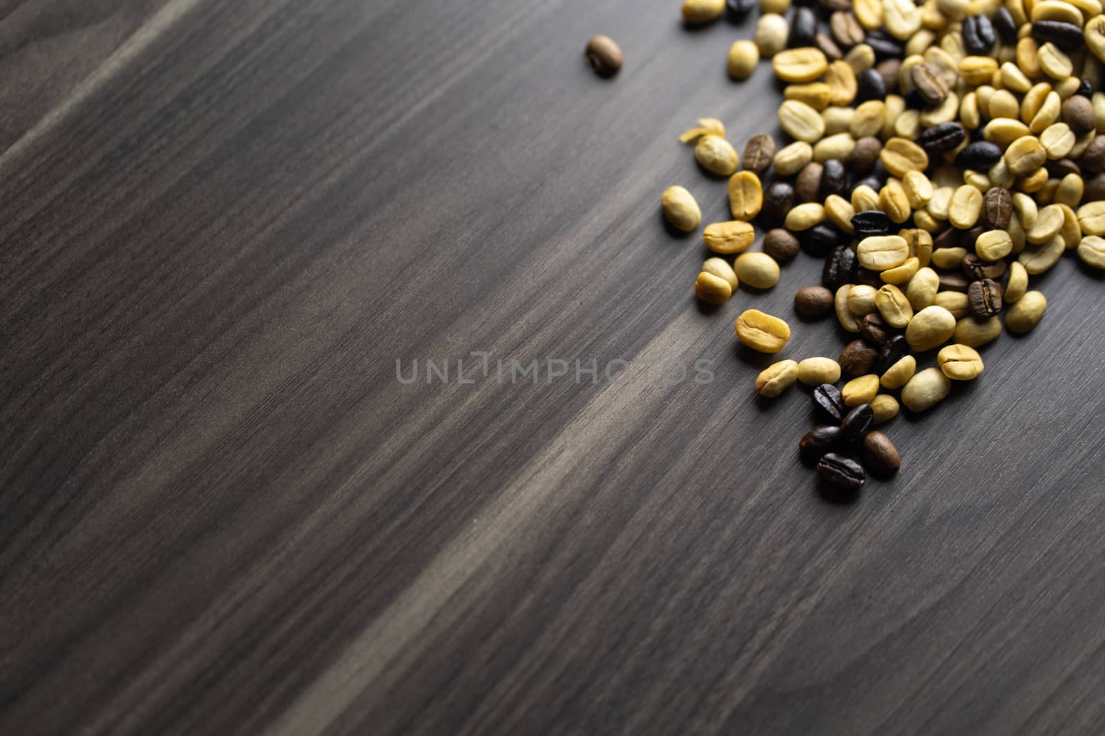 Coffee beans. Coffee beans that have not been baked on the wood floor.