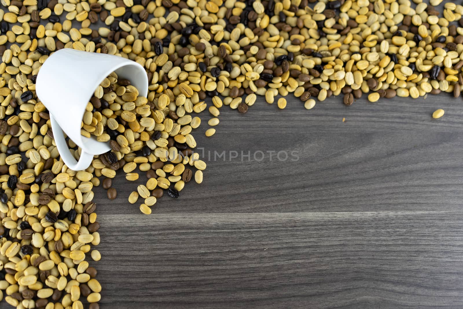 Coffee cup scoop Coffee beans that have not yet been roasted on the wooden floor