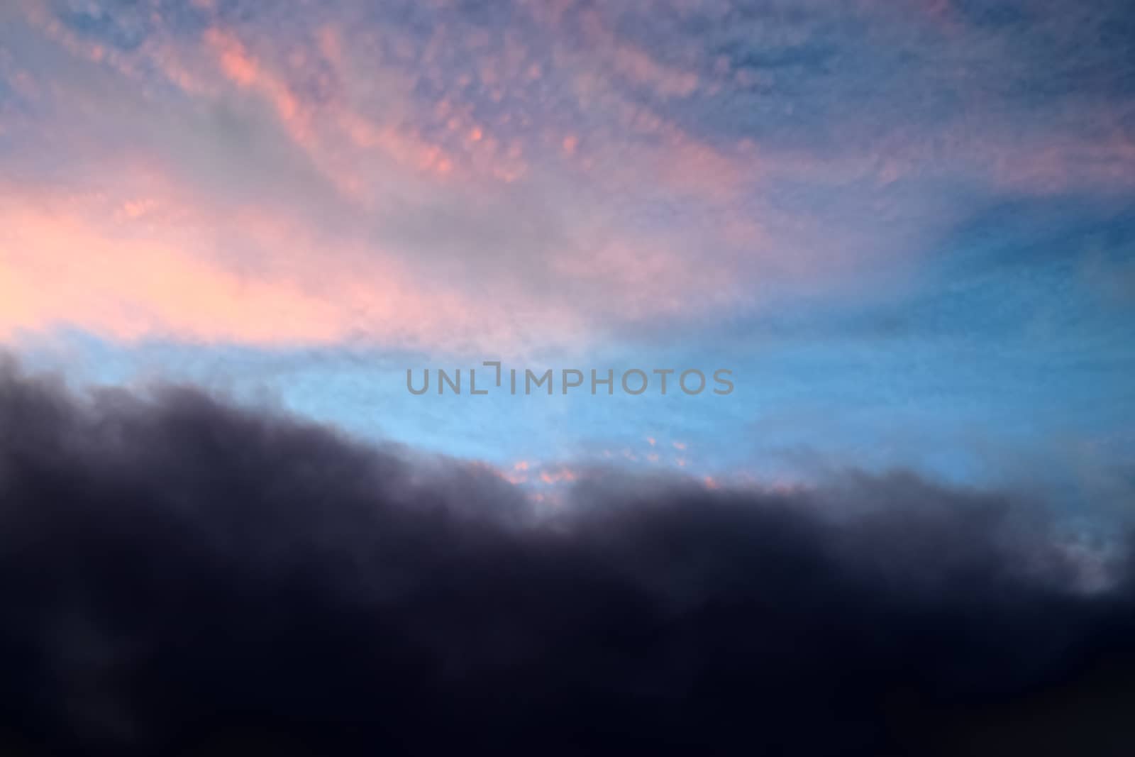 Beautiful panorama of orange and yellow clouds at sunrise and sunset in a blue sky