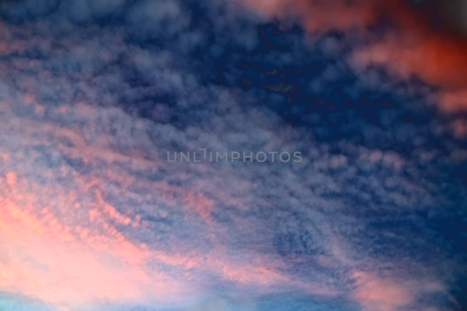 Beautiful panorama of orange and yellow clouds at sunrise and sunset in a blue sky