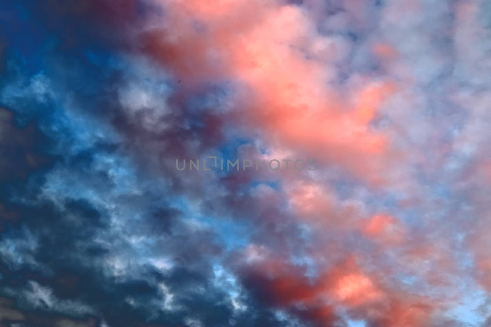 Beautiful panorama of orange and yellow clouds at sunrise and sunset in a blue sky