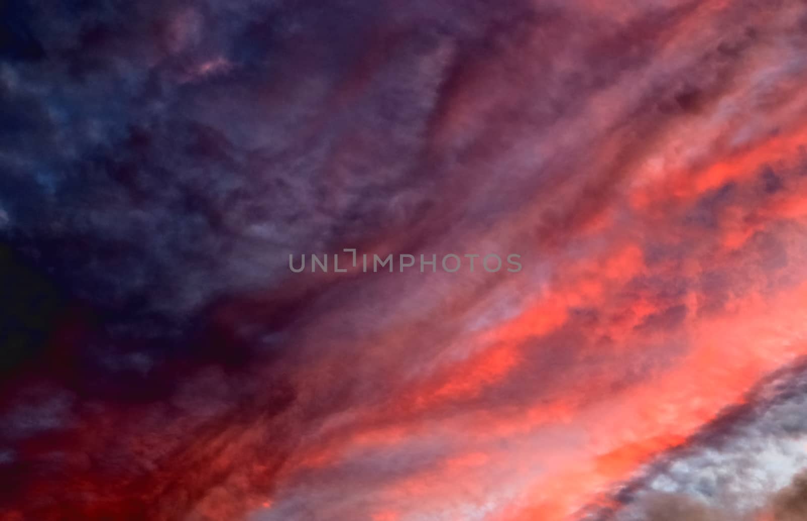 Beautiful panorama of orange and yellow clouds at sunrise and sunset in a blue sky