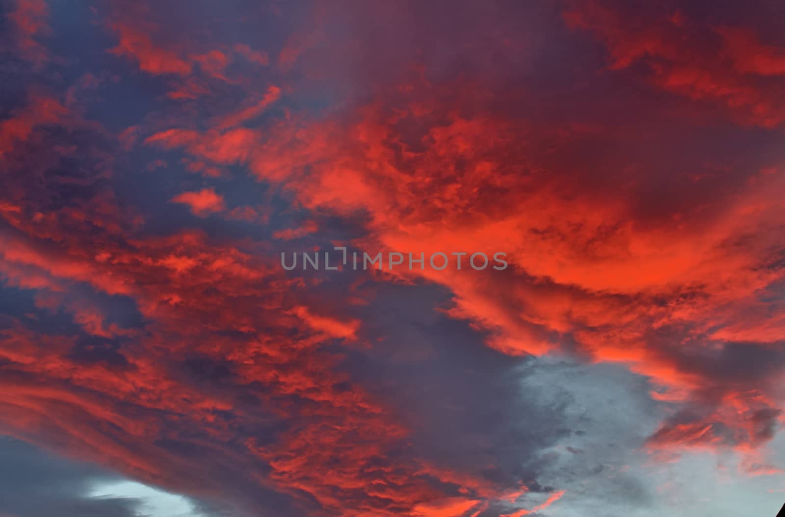 Beautiful panorama of orange and yellow clouds at sunrise and sunset in a blue sky