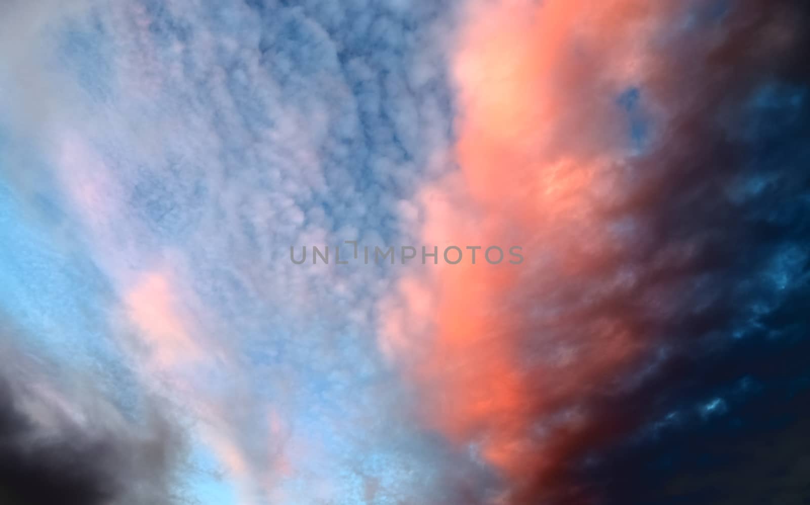 Beautiful panorama of orange and yellow clouds at sunrise and sunset in a blue sky