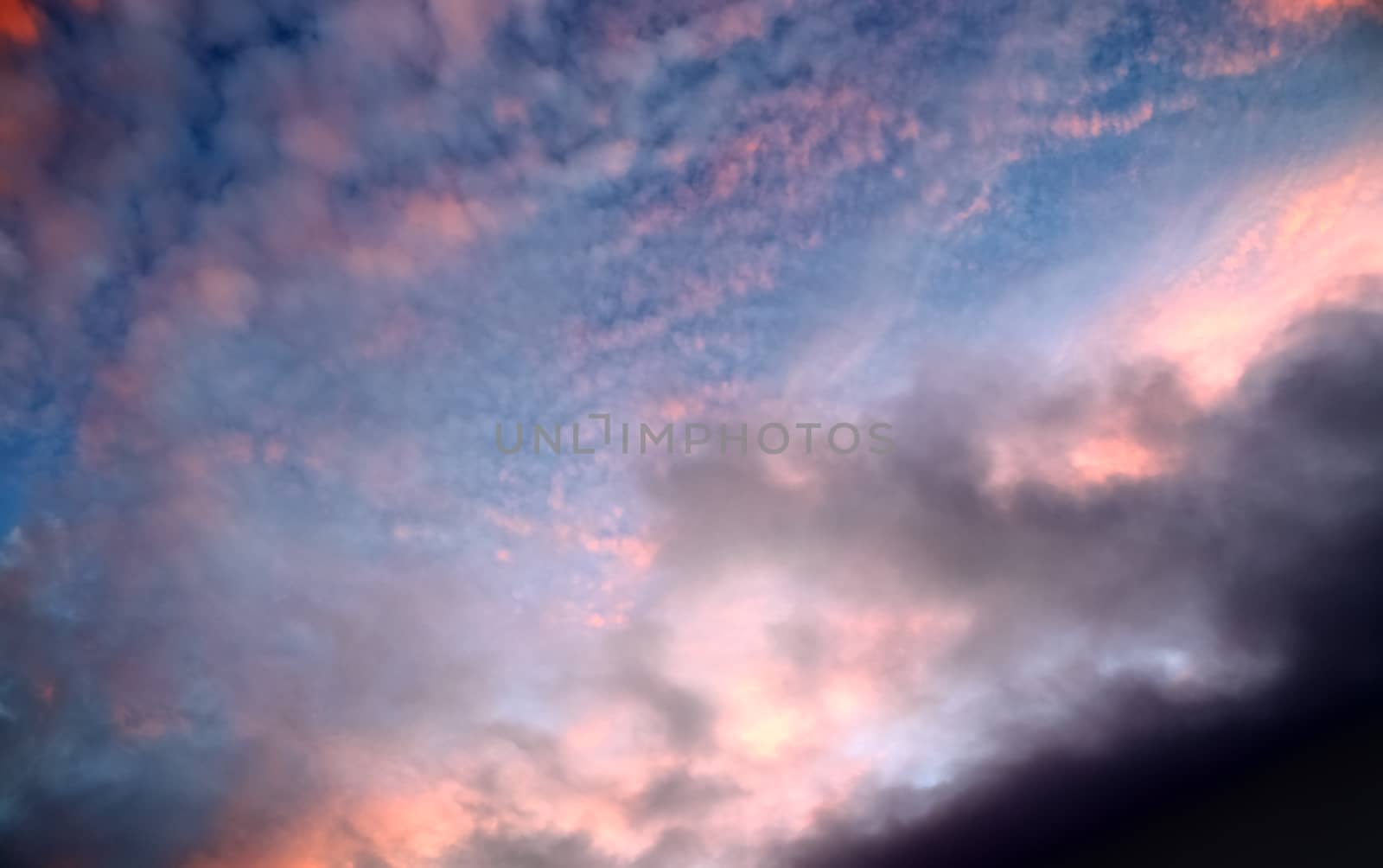 Beautiful panorama of orange and yellow clouds at sunrise and sunset in a blue sky