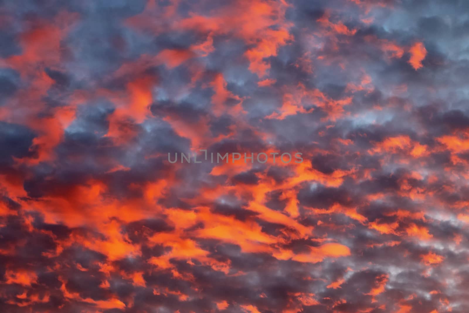 Beautiful panorama of orange and yellow clouds at sunrise and sunset in a blue sky