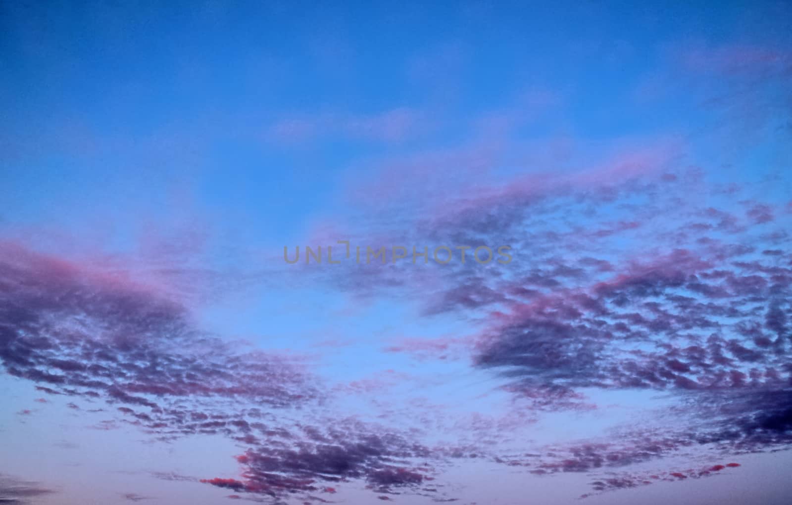 Beautiful panorama of orange and yellow clouds at sunrise and sunset in a blue sky